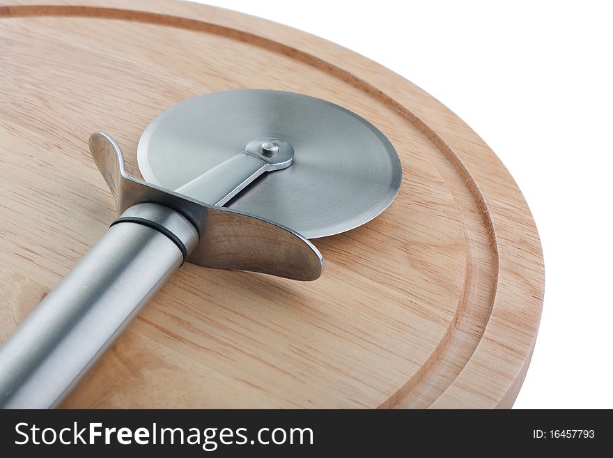 Stainless steel pizza cutter on wooden chopping board, isolated on white. Stainless steel pizza cutter on wooden chopping board, isolated on white