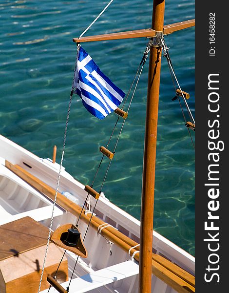 The Flag of Greece on a rowboat in the harbor of a Greek island. The Flag of Greece on a rowboat in the harbor of a Greek island.