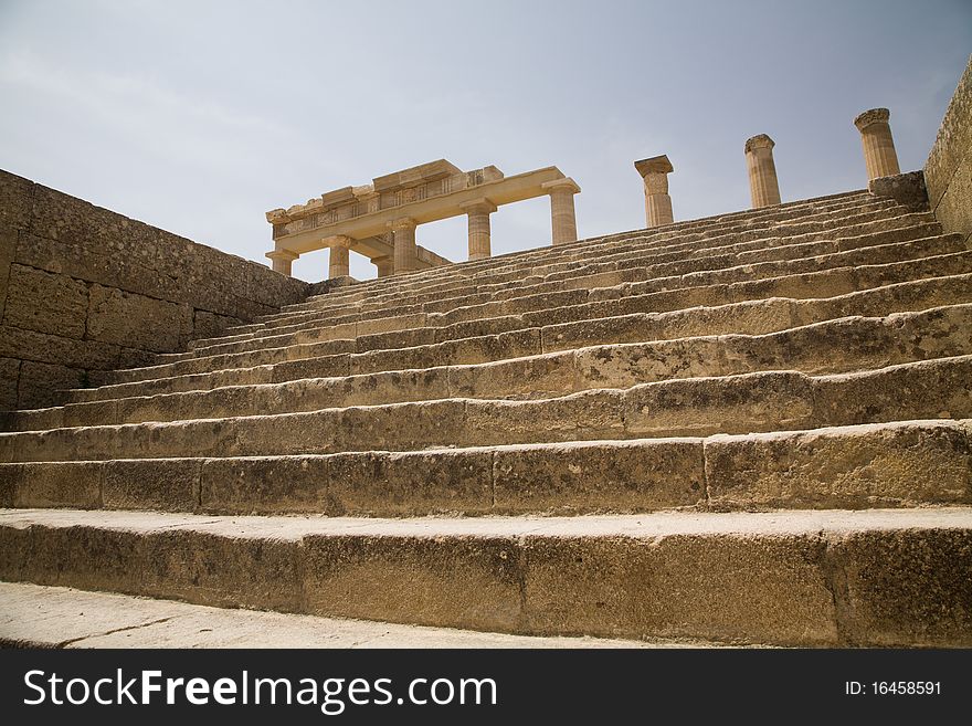 Close-up of the main stairs and what remains of the doric columns of the Acropolis of Lindos, on the Greek island of Rhodes. Close-up of the main stairs and what remains of the doric columns of the Acropolis of Lindos, on the Greek island of Rhodes.