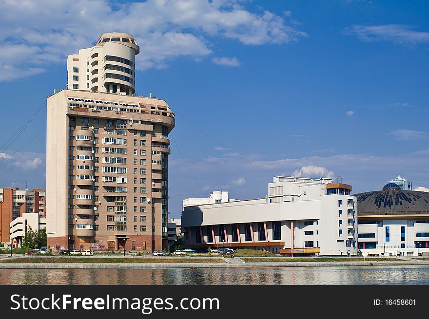 Modern city view with the river in front shot in bright sunlight