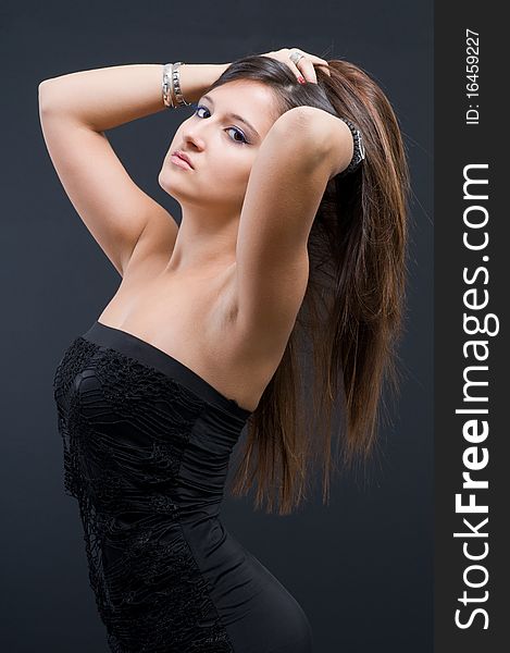 Attractive woman in evening gown on dark backgrouinds