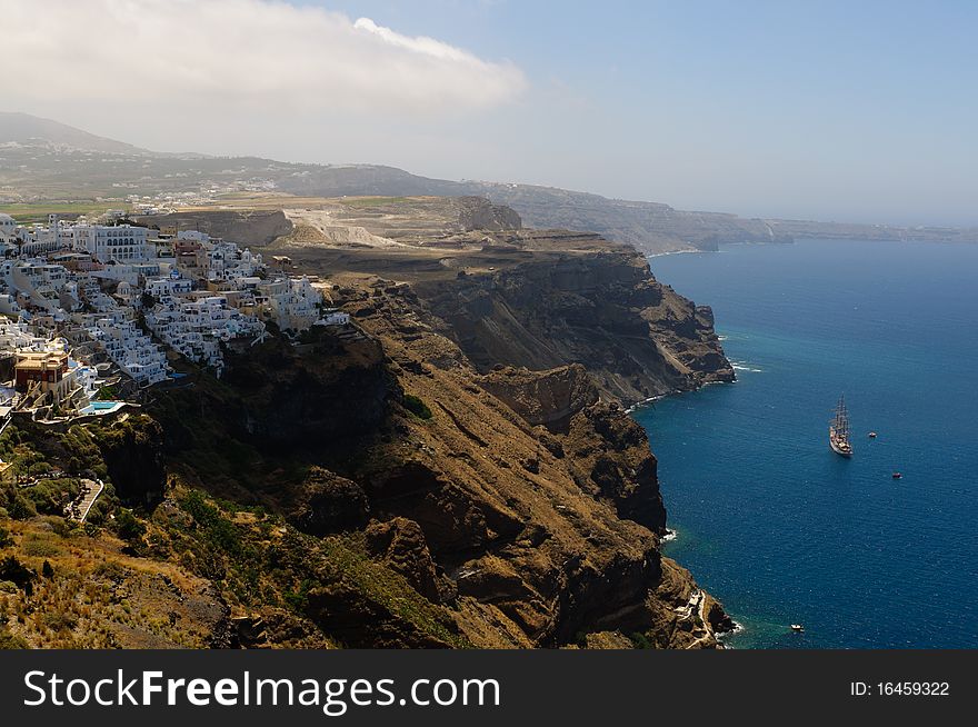 View on the sea and the typical houses of a village in the steep coast on top of the caldera in Santorini, Greece. View on the sea and the typical houses of a village in the steep coast on top of the caldera in Santorini, Greece.