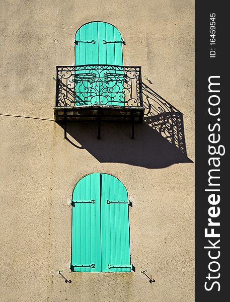 Shuttered Window With Ornate Balcony