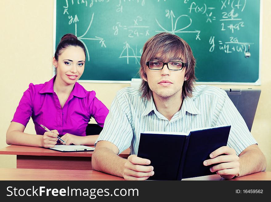 Educational theme: happy students in a classroom.