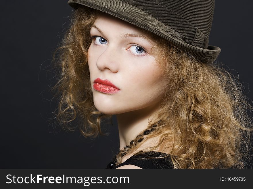 Portrait of beautiful young woman with hat