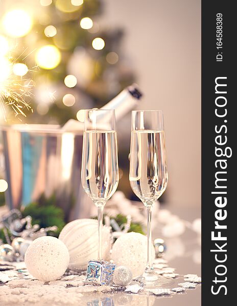 Christmas and New Year celebration with champagne. Holiday dinner table setting with Christmas tree decoration