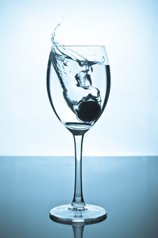 Splash Of Water And Coins In A Glass Stock Photo Splash Of Water And Coins In A Glass Stock Photo