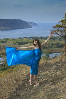 A Young Girl In A Blue Dress Dancing On A Mountain Stock Photo A Young Girl In A Blue Dress Dancing On A Mountain Stock Photo
