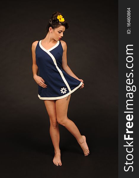A pretty pin up girl in a sailor dress.