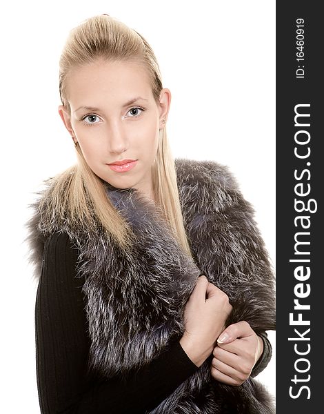 Blonde girl in fur jacket isolated on white