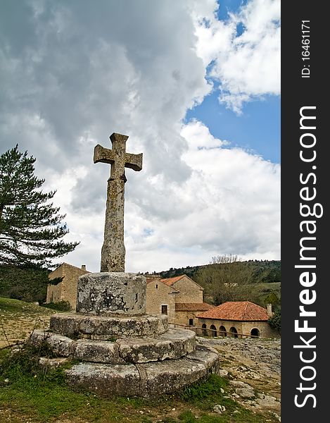 Old stone cross in town of Spain