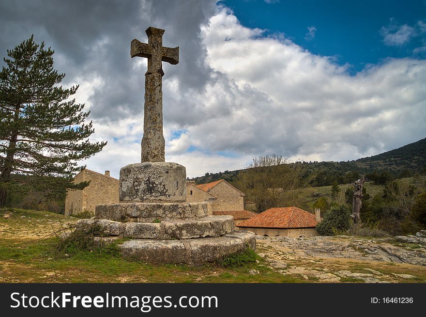 Old stone cross in town of Spain