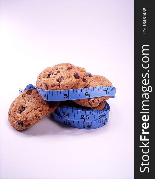 Chocolate chip cookies wrapped with a measuring tape. Chocolate chip cookies wrapped with a measuring tape