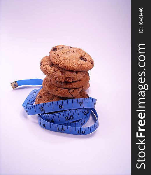 Chocolate chip cookies wrapped with a measuring tape. Chocolate chip cookies wrapped with a measuring tape