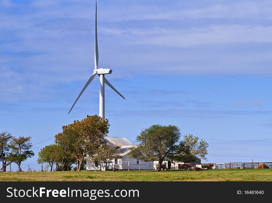 Wind Generator Towering Above An Old Farm House