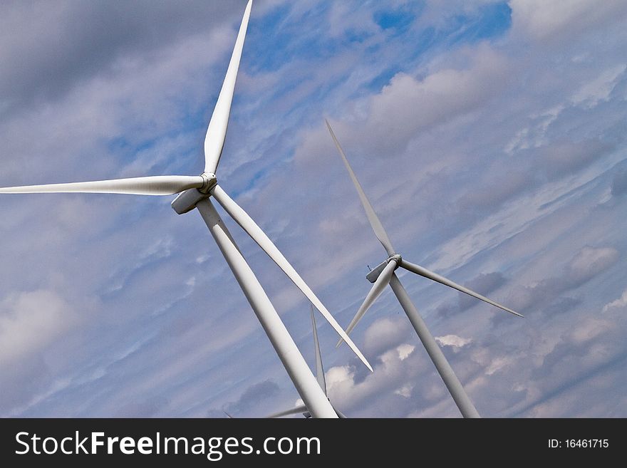 Dutch angle of two wind generators and horizontal bands of clouds. Dutch angle of two wind generators and horizontal bands of clouds