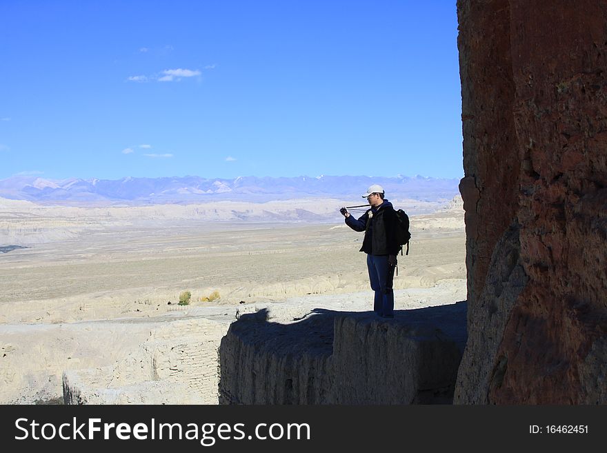 A photographer is looking into view finder, Tibet, China. A photographer is looking into view finder, Tibet, China