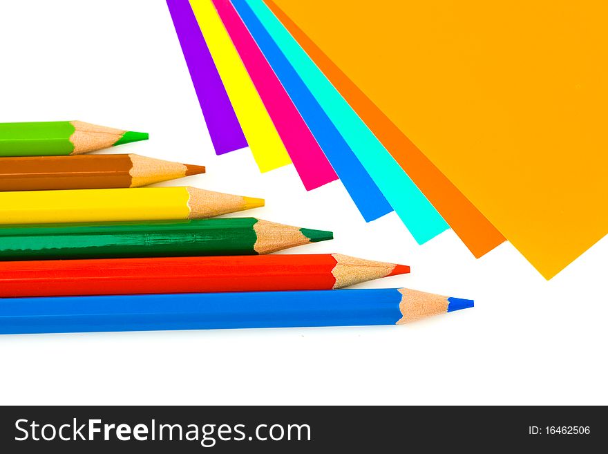 Multicolored paper and pencils isolated on white background