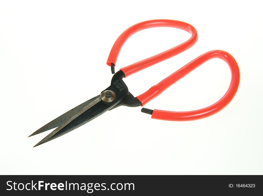 A red scissors on a white background