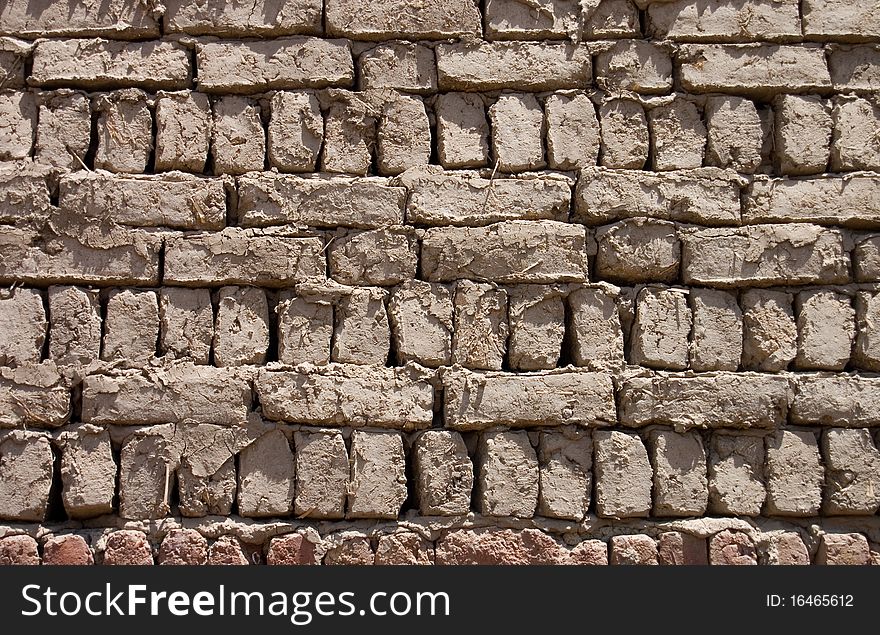 Wall from clay bricks as a background close up