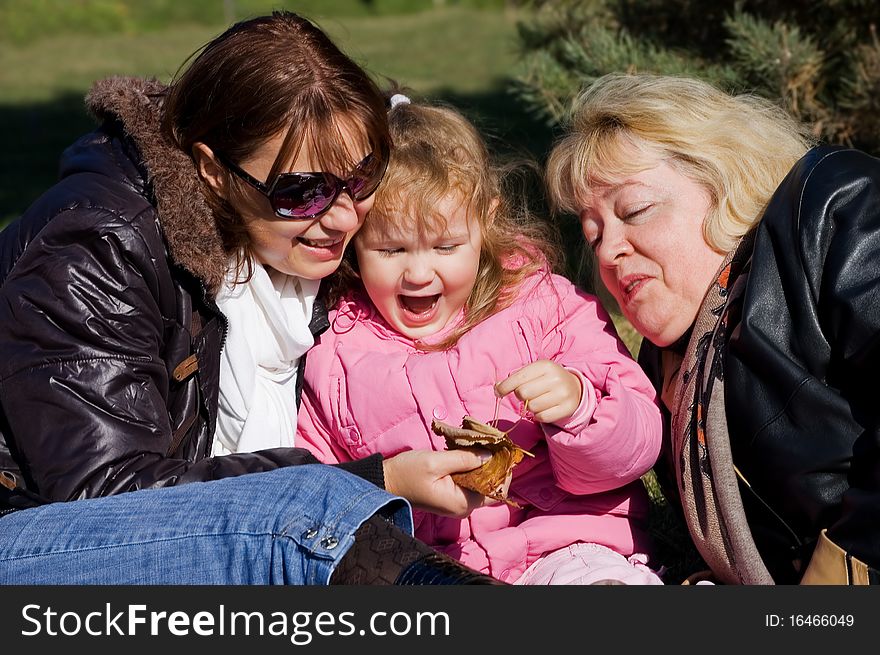 Happy Family In Autumn Park