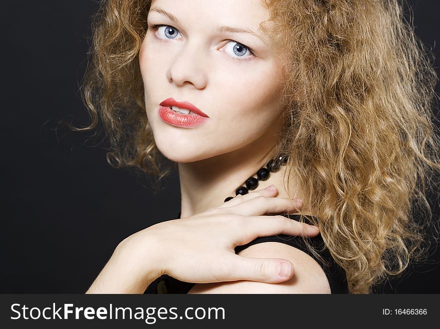 Image of beautiful young woman with curly hairs looking at camera