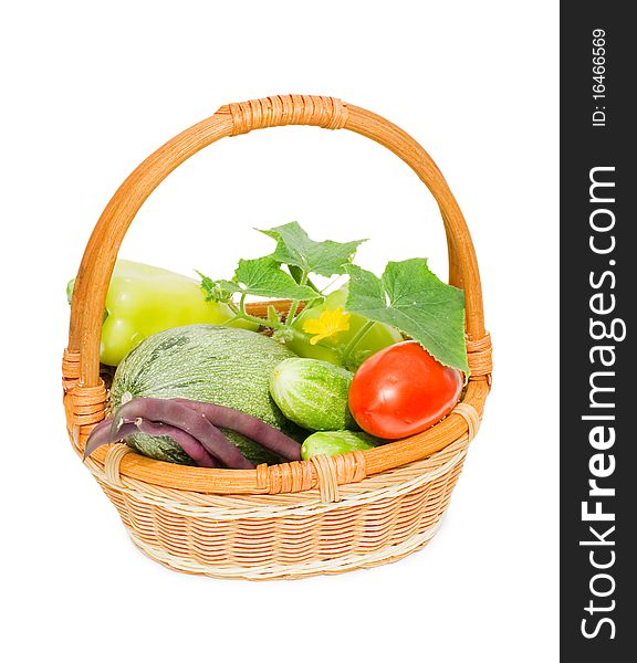 Wattled basket with vegetables isolated on white