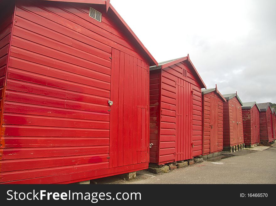 Row of red beach huts on Jersey in Channel Islands. Row of red beach huts on Jersey in Channel Islands