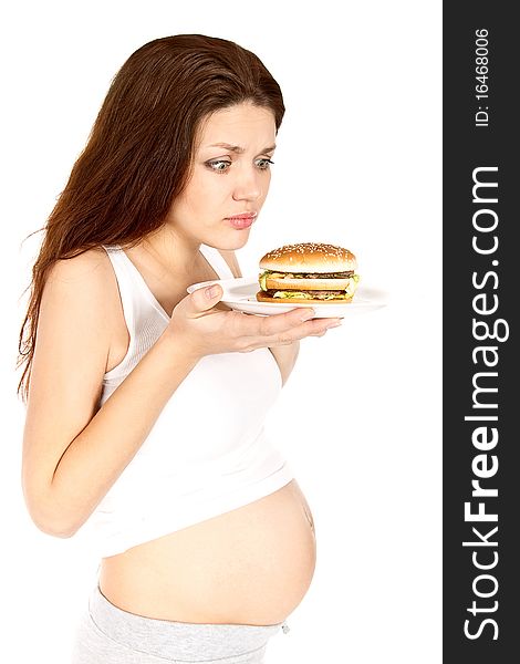 Pregnant woman eats a sandwich. Pregnant woman eats a sandwich