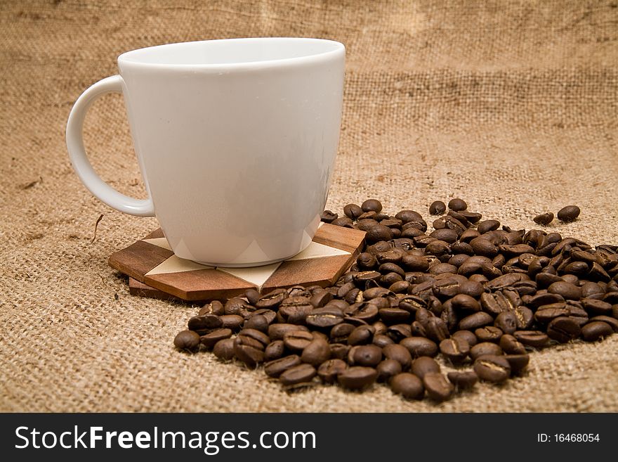 Grains and cup of coffee on a background rough material