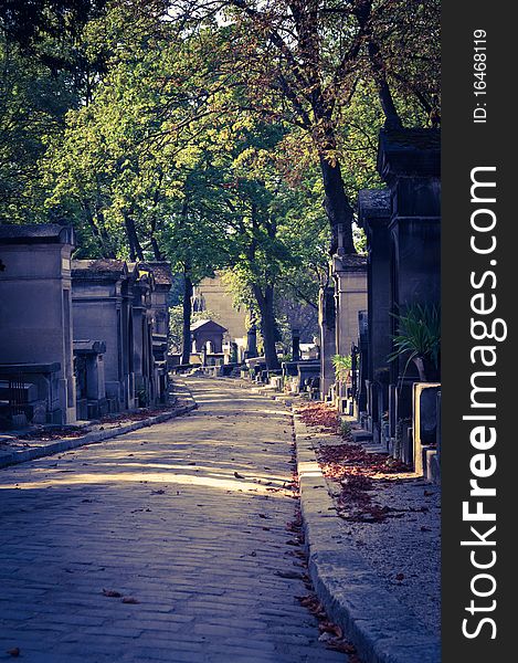 An autumn leaf covered street in Pere Lachaise Cemetary in Paris. An autumn leaf covered street in Pere Lachaise Cemetary in Paris