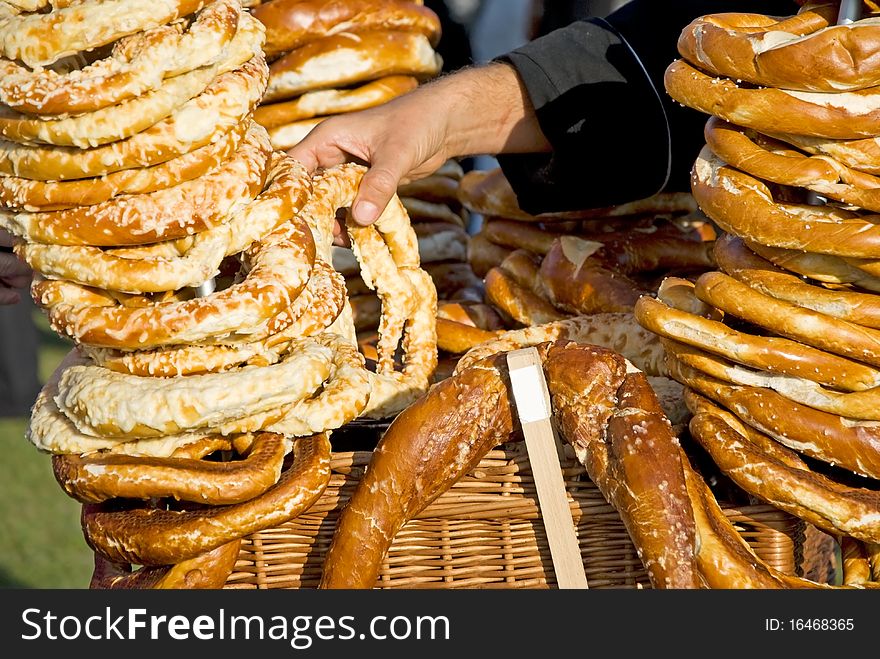 Man, selling german pretzels on the oktoberfest. Man, selling german pretzels on the oktoberfest