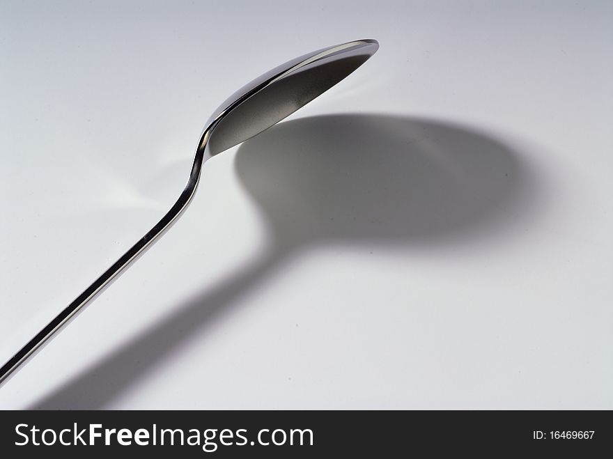 Steel spoon and his shadow