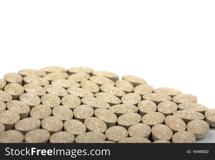 Heap of grassy tablets on a white background it is isolated