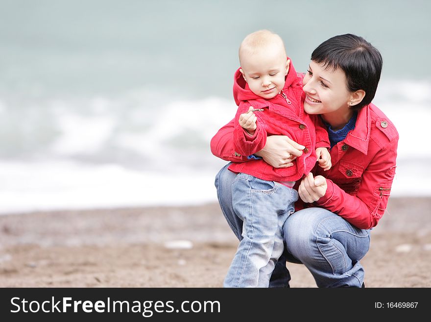 Loving mother and child on sea background