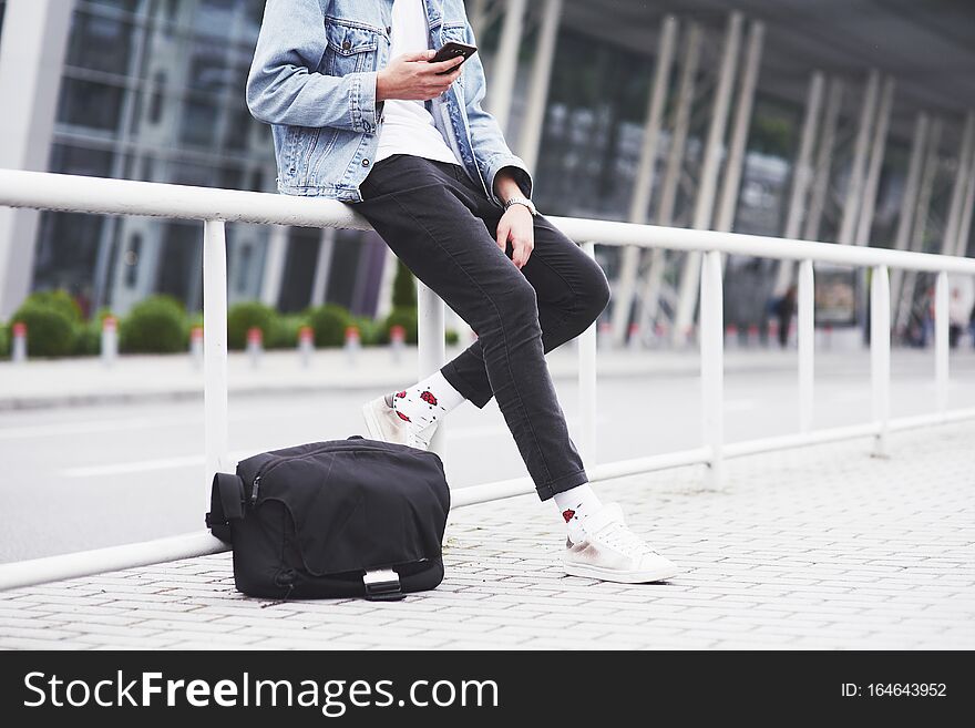 A Young Man Is Waiting For A Passenger At The Airport.