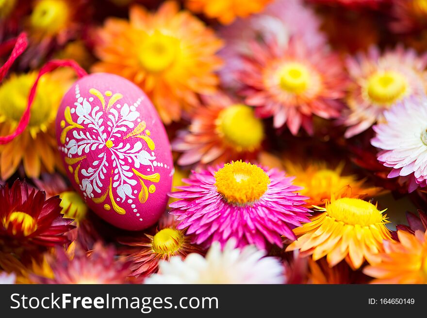 Hand-painted easter egg with many colorful straw flowers. Hand-painted easter egg with many colorful straw flowers