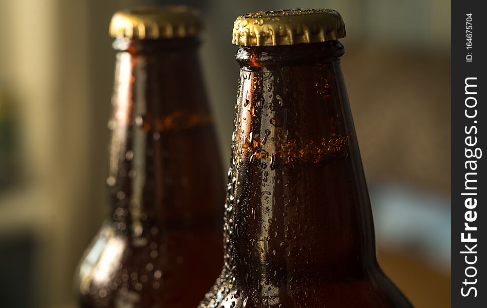 Colored  abstract glass of cold beer and botle chips on wooden table background for your text. Colored  abstract glass of cold beer and botle chips on wooden table background for your text