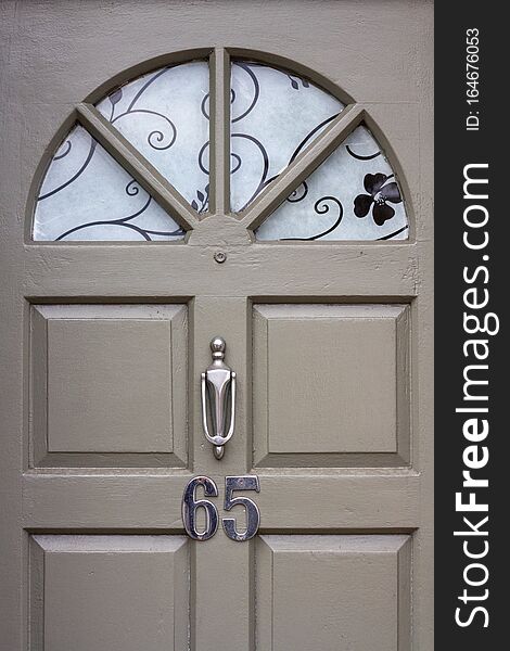 Elegant front door with the number 65