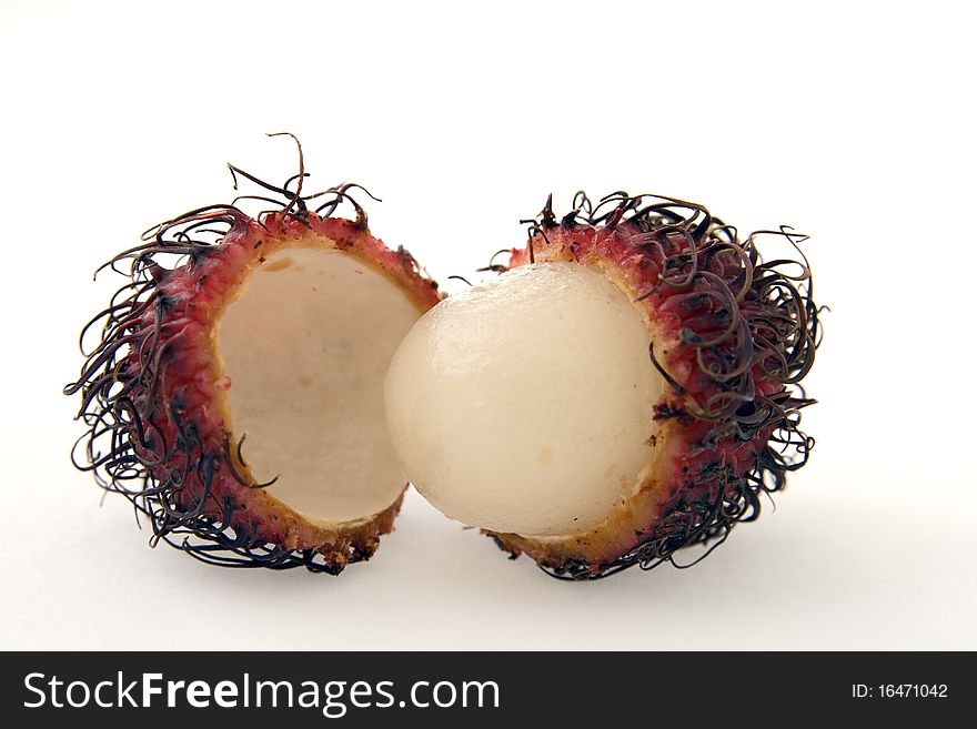 Rambutan fruit cut and ready to eat. Shot on white background. Rambutan fruit cut and ready to eat. Shot on white background