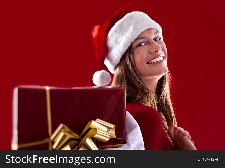 Smiling Santa Girl with gifts on red background