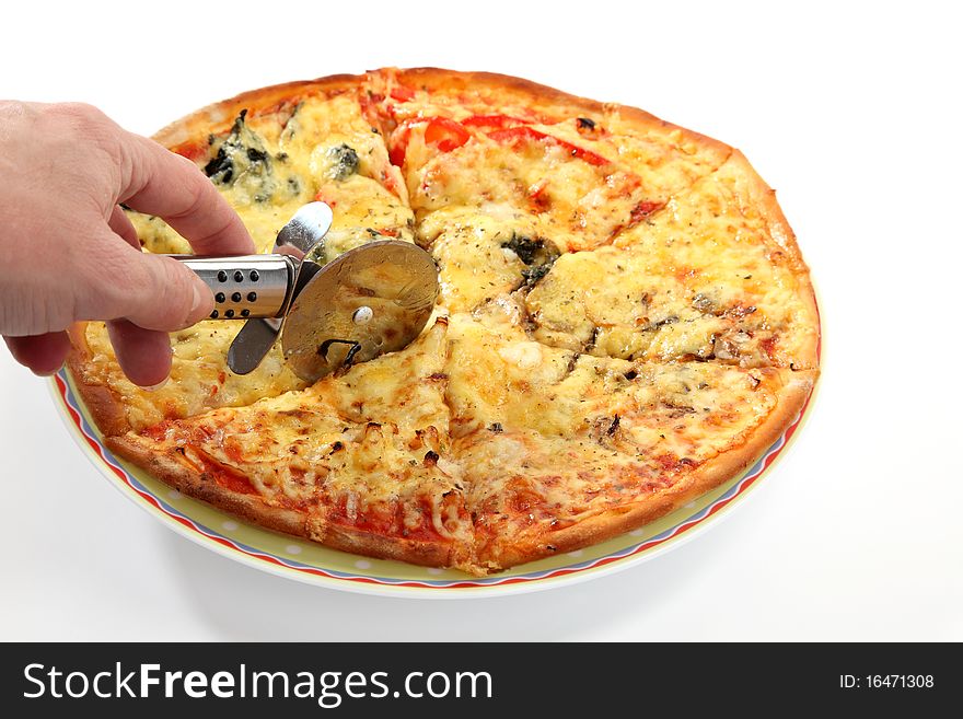 A woman cuts a slice of pizza. A woman cuts a slice of pizza