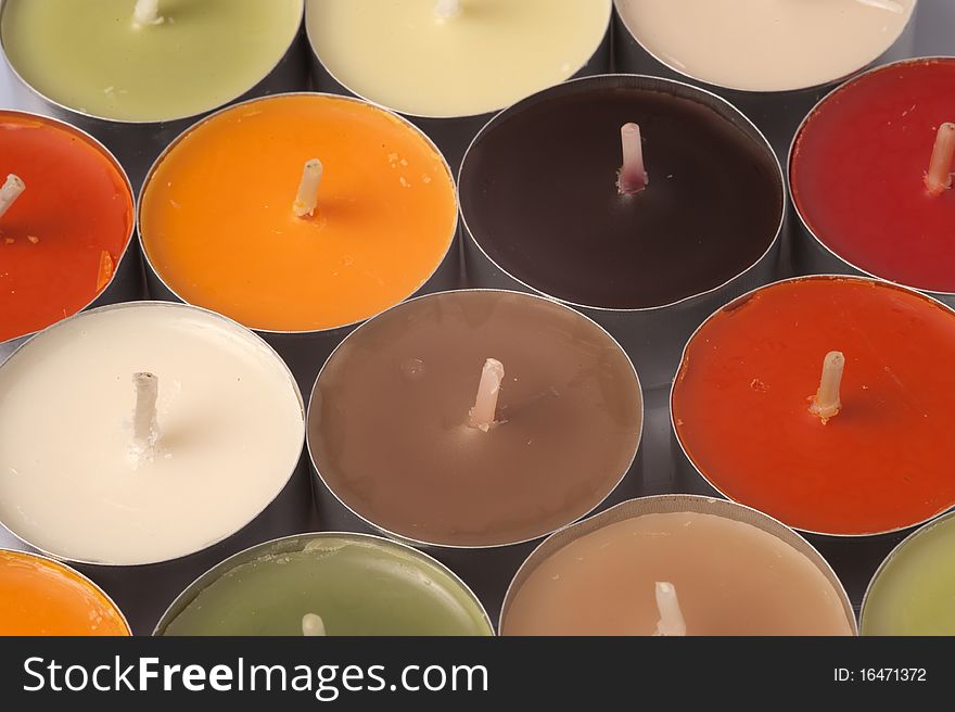 Various color candles on a white background