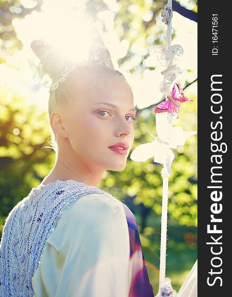 Beauty outdoor portrait with defocused forest background