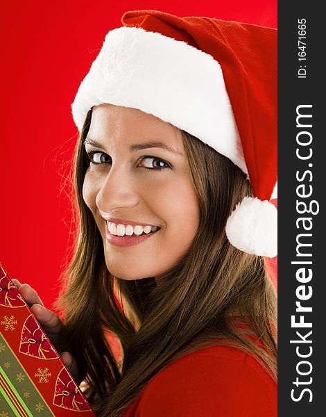 Portrait of a smiling Santa Girl with present