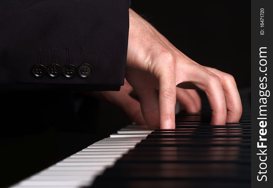 A pianist plays a concert. View on his fingers