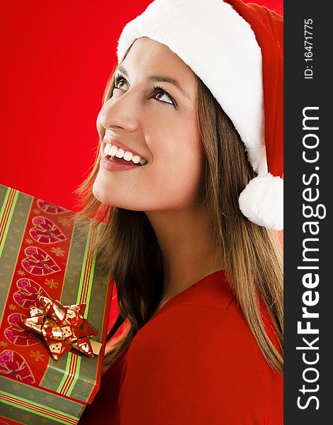 Portrait of a smiling Santa Girl with present