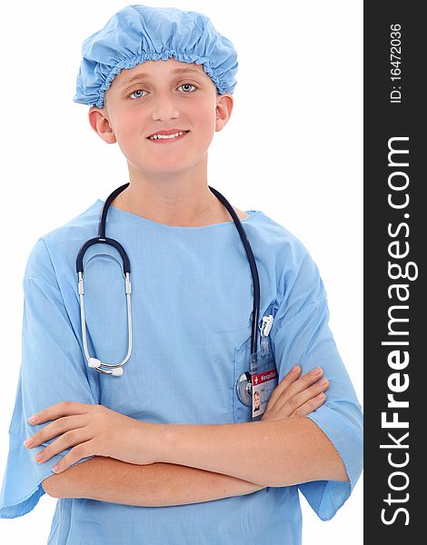 Adorable 12 year old boy dressed in surgical scrubs over white background. Adorable 12 year old boy dressed in surgical scrubs over white background.
