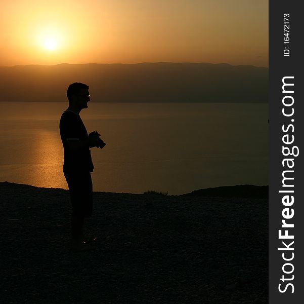 Photographer during sunrise over the dead sea in Israel