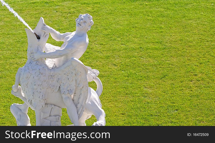 Statue - fountain on a grass background